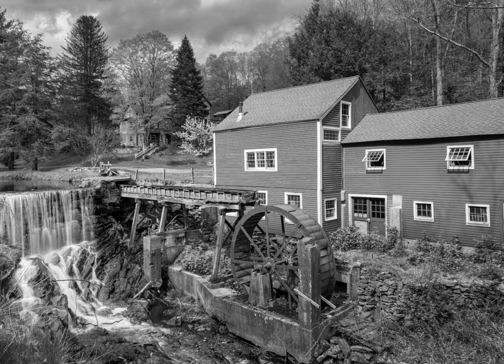 old mill on the river and a waterfall in Bridgewater Connecticut in black white