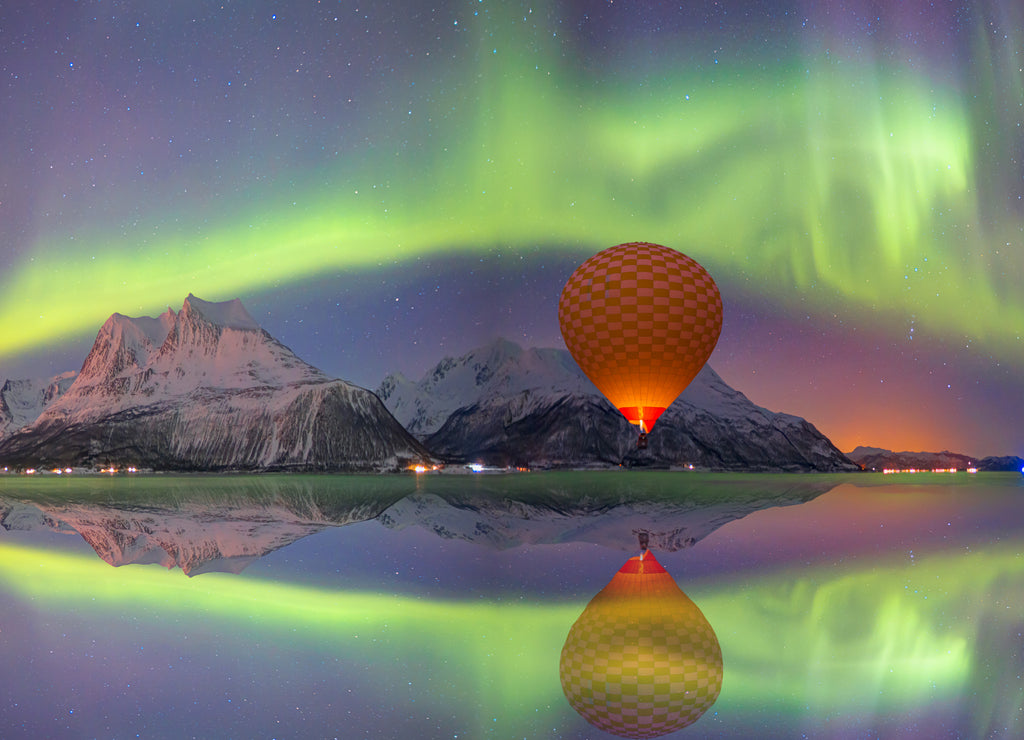 Hot air balloon over Tromsö, Norway, with spectacular northern lights