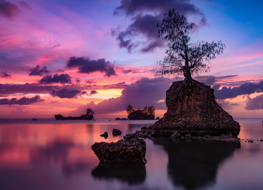 Landscape of a lake with long exposure during a breathtaking sunset in Apaca Point, Guam