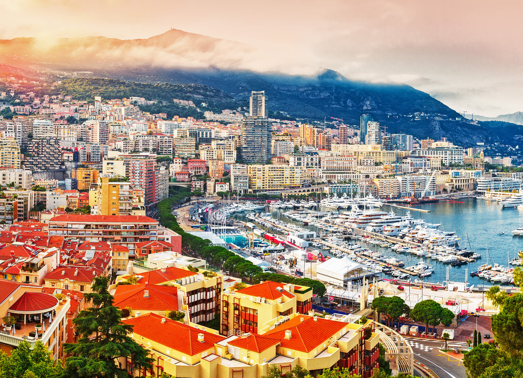 Principality of Monaco. Picturesque panoramic view of Monaco at sunset. View of residential buildings, casino, harbor with luxury yachts. Monaco is a popular destination for gambling