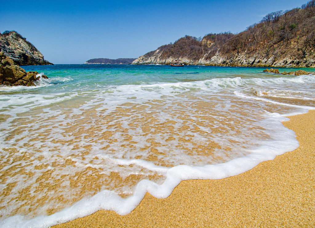 Paradise sandy beach with turquoise water in Huatulco, Oaxaca, Mexico