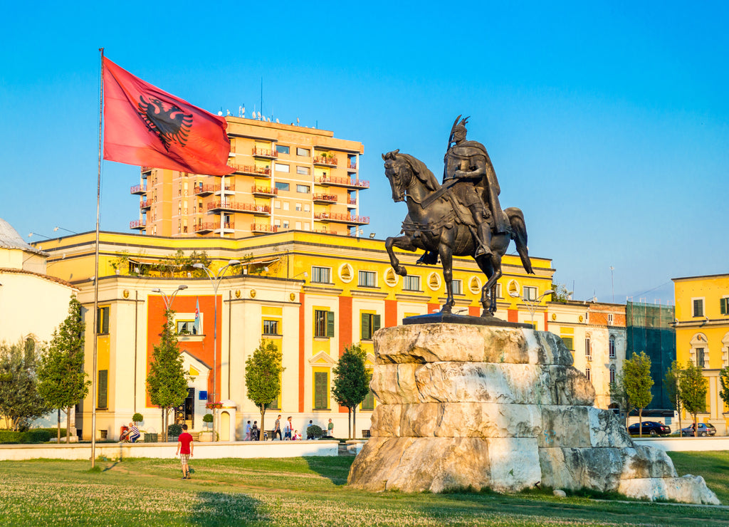 Skanderbeg square with flag, Skanderbeg monument and The Et'hem Bey Mosque in the center of Tirana city, Albania