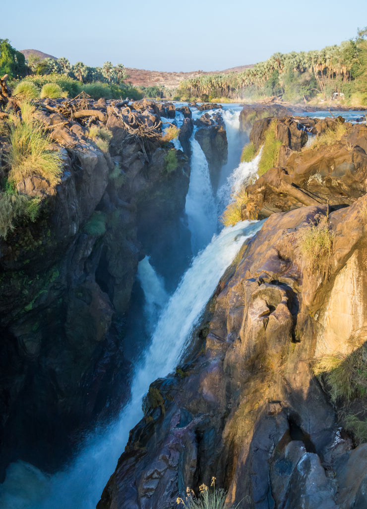 View over beautiful scenic Epupa Falls on Kunene River between Angola and Namibia in evening light