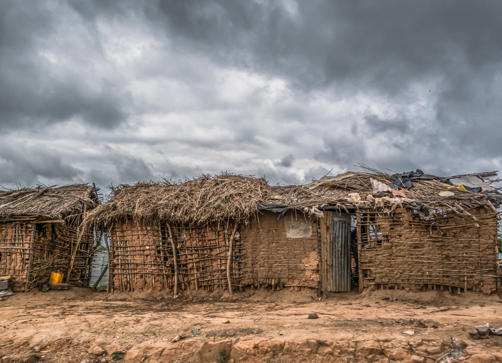 View of traditional village, house thatched with roof and terracotta walls in Angola