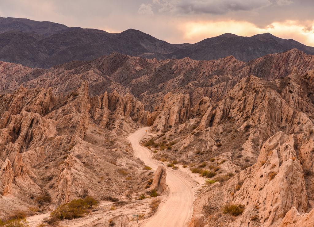 The famous Ruta 40 road at sunset winding through the geological wonders of the Quebrada de Las Flechas, Valles Calchaquíes, Salta, Northwest Argentina