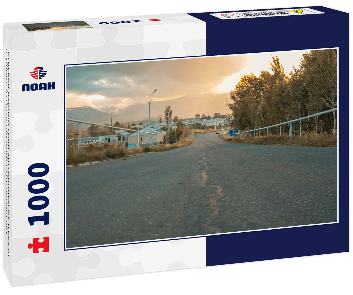 Cracked asphalt road surrounded by trees in a village in Armenia under the sunset sky