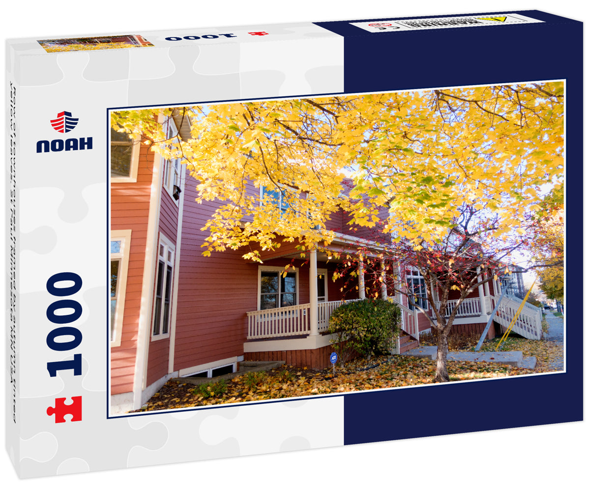 Row of townhouses framed by autumn tinted yellow leaves. St Paul Minnesota MN USA