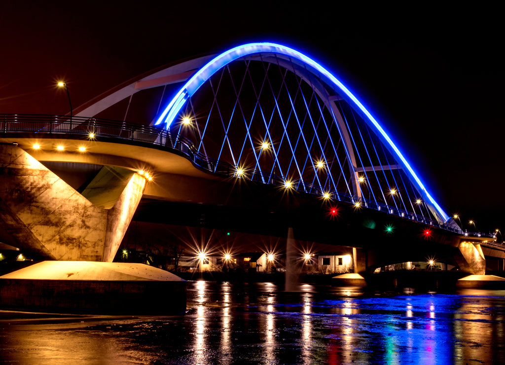 Lowry Avenue Bridge colored blue at dusk with Minneapolis Skyline