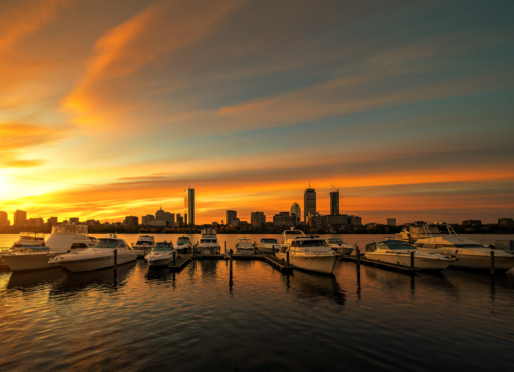 Sunrise over Boston city with boat and harbor, Massachusetts cityscape