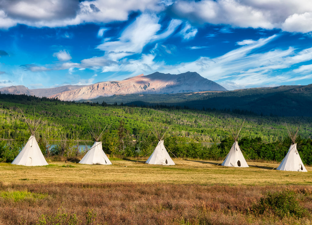 Tipi in a field with American Rocky Mountain Landscape in the background, Montana near Glacier National Park