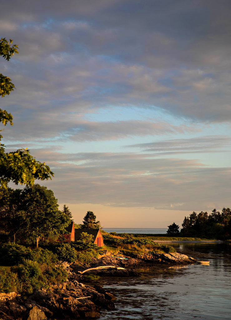 Old red cottage at sunset on the coast in Maine at Sagadahoc Bay