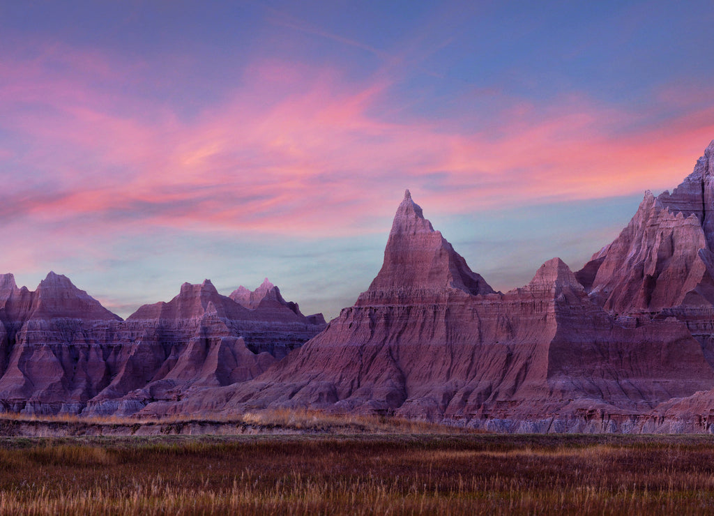 Panorama of Eroded Mountains of Badlands National Park, South Dakota, During a Pink Sunset