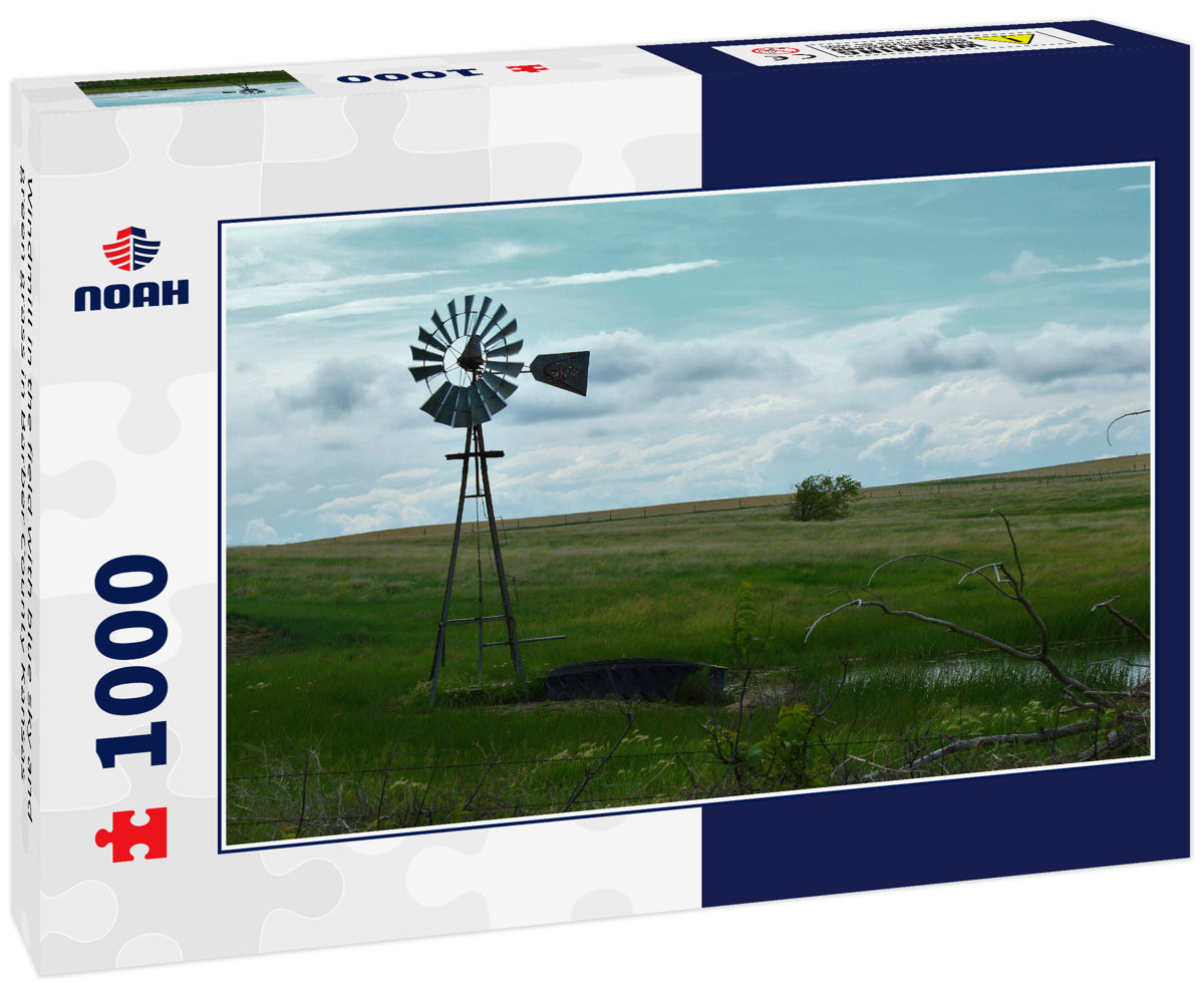 Windmill in the field with blue sky and green grass in Barber County Kansas