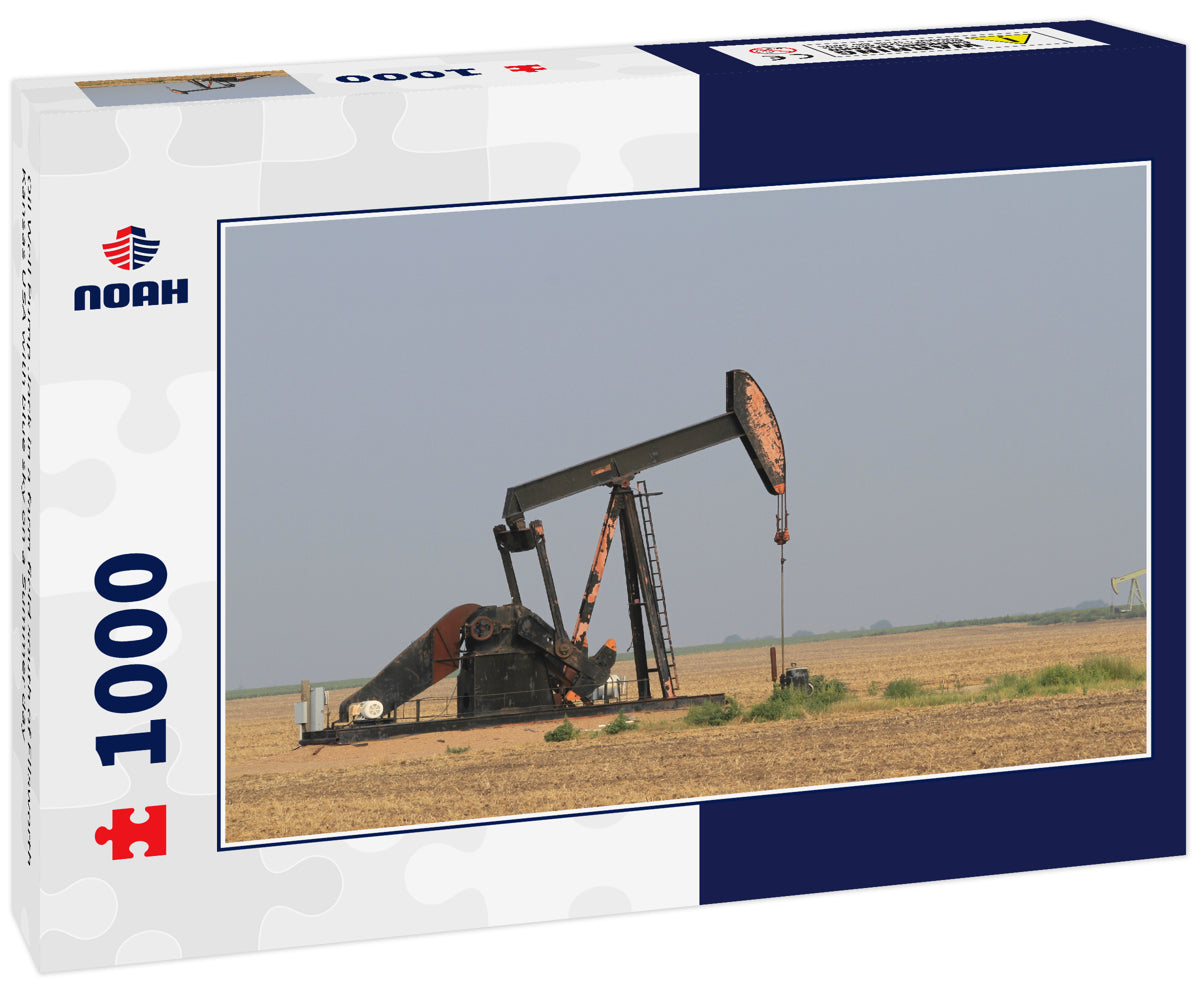 Oil Well Pump Jack in a farm field south of Ellsworth Kansas USA with blue sky on a Summer day