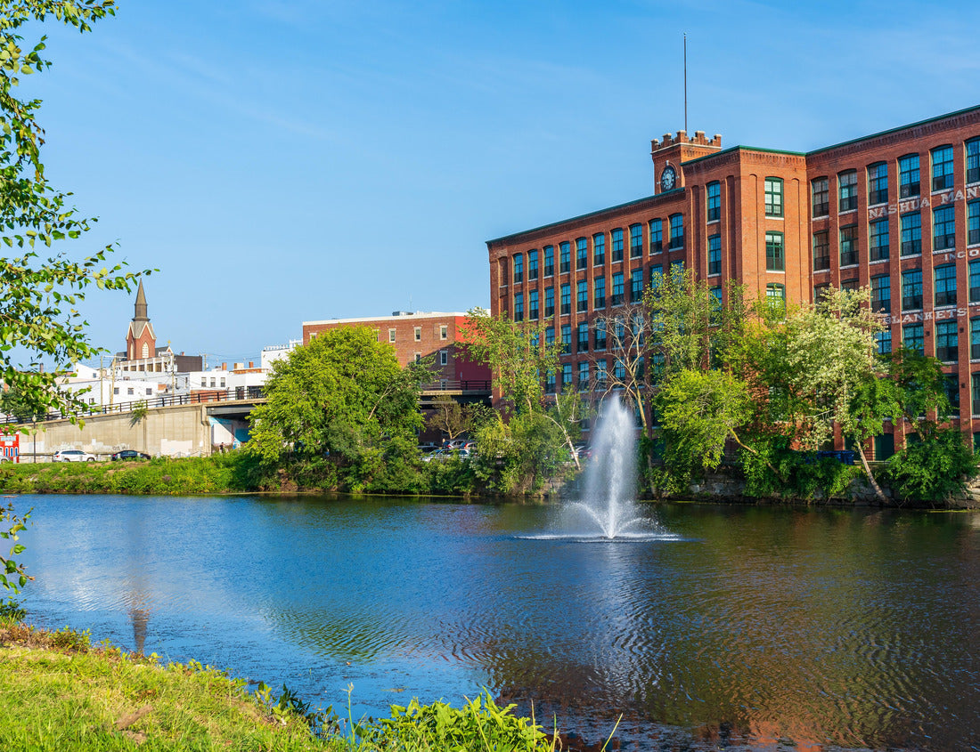 Noah Jigsaw Puzzle Fountain on the Nashua River against the background of a historic cotton factory building with a clock tower in the old industrial park of Nashua. New Hampshire, USA 1000 pieces