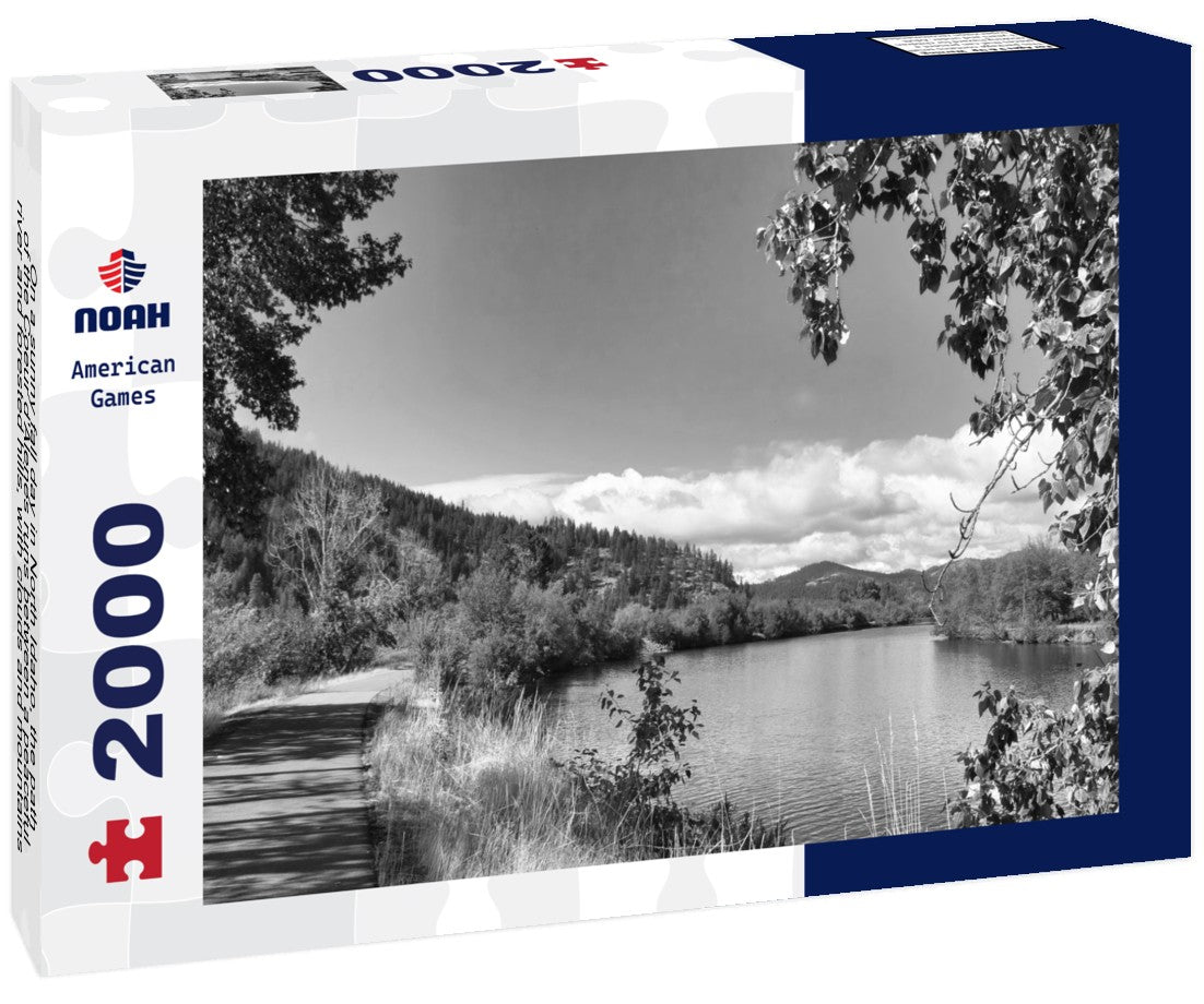 Noah Jigsaw Puzzle On a sunny fall day in North Idaho, the path of the Coeur d'Alenes runs between a peaceful river and forested hills, with clouds and mountains in the distance in black white 2000 pieces