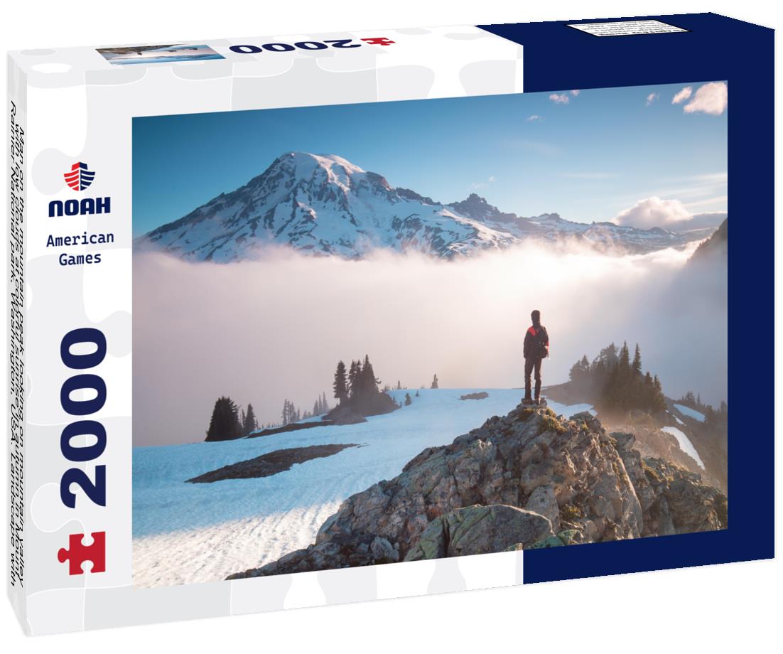 Noah Jigsaw Puzzle Man on the mountain peak looking on mountain valley with low clouds at colorful sunrise in autumn in Mount Rainier National park, Washington, USA 2000 pieces