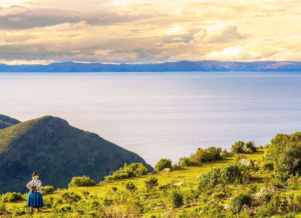 View on Indigenous woman on isla de Sol by lake Titicaca in Bolivia