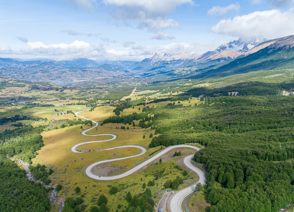Aerial view of the curved asphalt road trough mountains. Carretera Austral road near the Cerro Castillo National Park. Chile