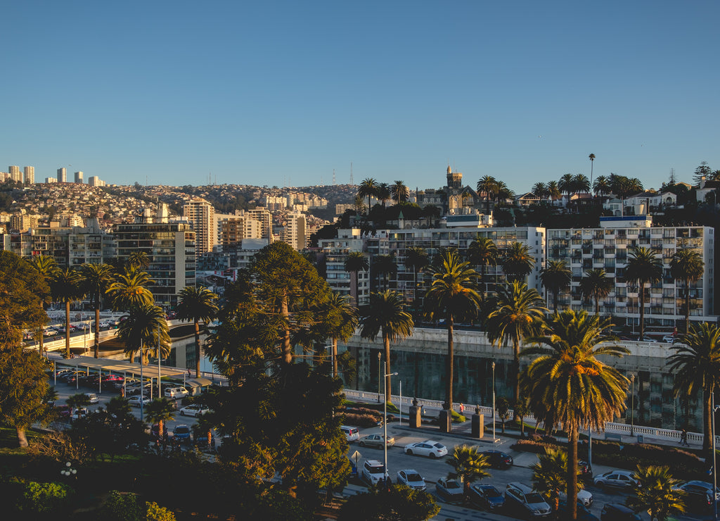 Day evening view of the skyline of the hills of Valparaiso and Viña del Mar with beautiful sunset light and Marga Marga river, Chile