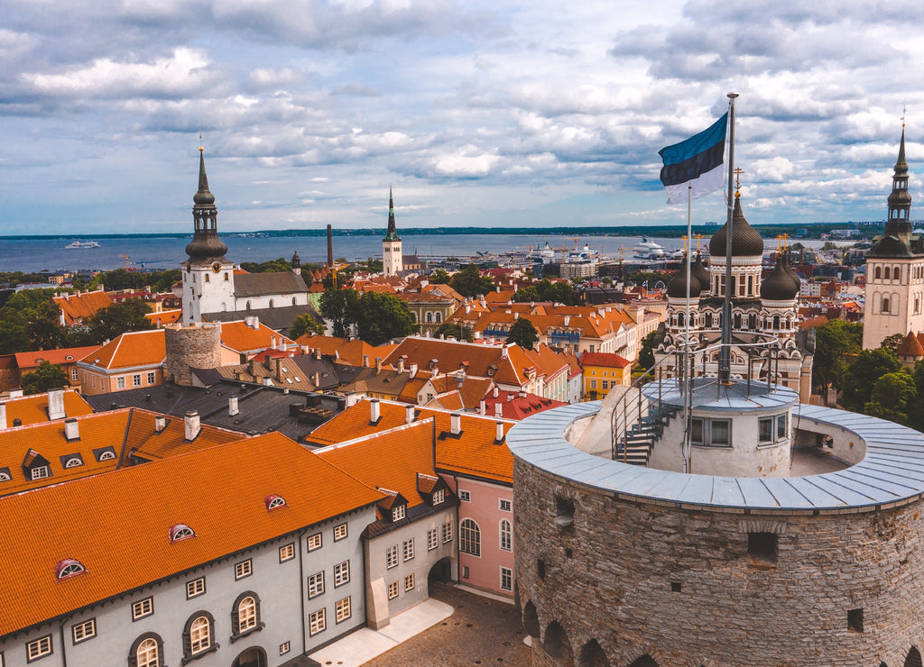 Close up view of the Estonian flag on top of the old medieval tower
