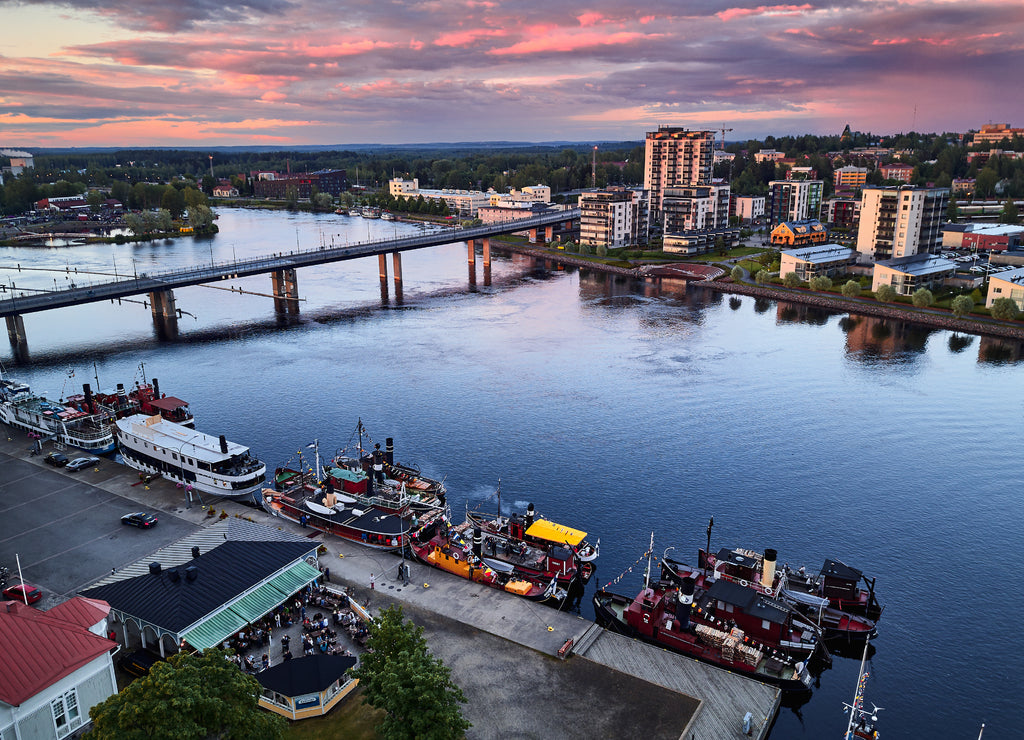 Aerial view of retro steamships at the pier on the Pielisjoki river in Joensuu, Finland. On the sky amazing bright sunset