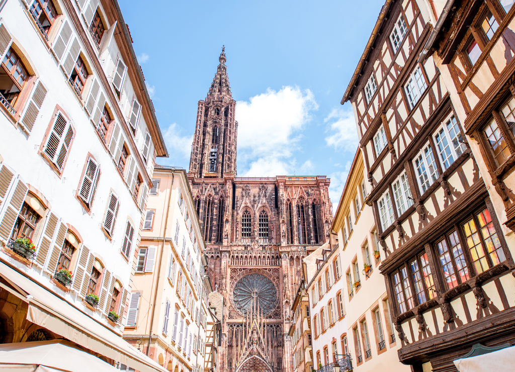 Street view from below on the beautiful old buildings and Notre-Dame cathedral in Strasbourg city
