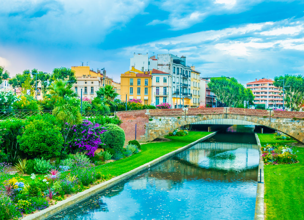 Sunset view over La Bassa river flowing through the city center of Perpignan, France