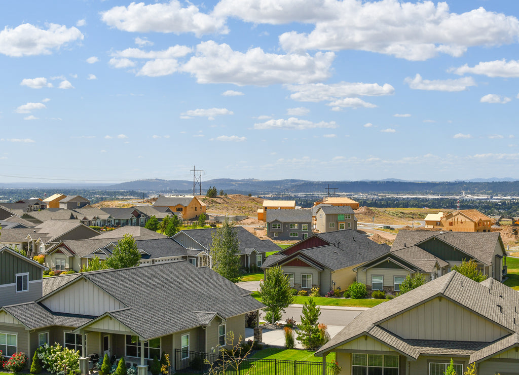 New construction homes being built in a subdivision hilltop overlooking a valley in an area of new homes in the Spokane, Washington area of the U.S.