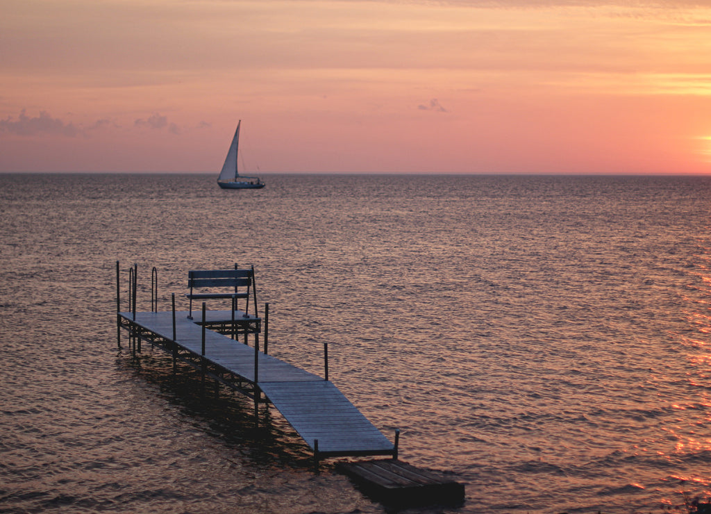 Sunset over a boat and small dock in Sister Bay in Door County, Wisconsin
