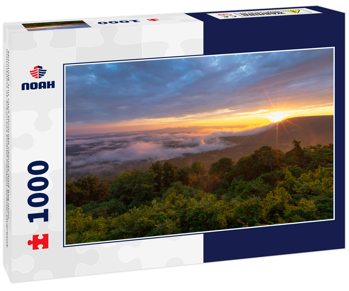 Morning sun rays through clouds and fog over mountains at Arkansas Grand Canyon Scenic Overlook