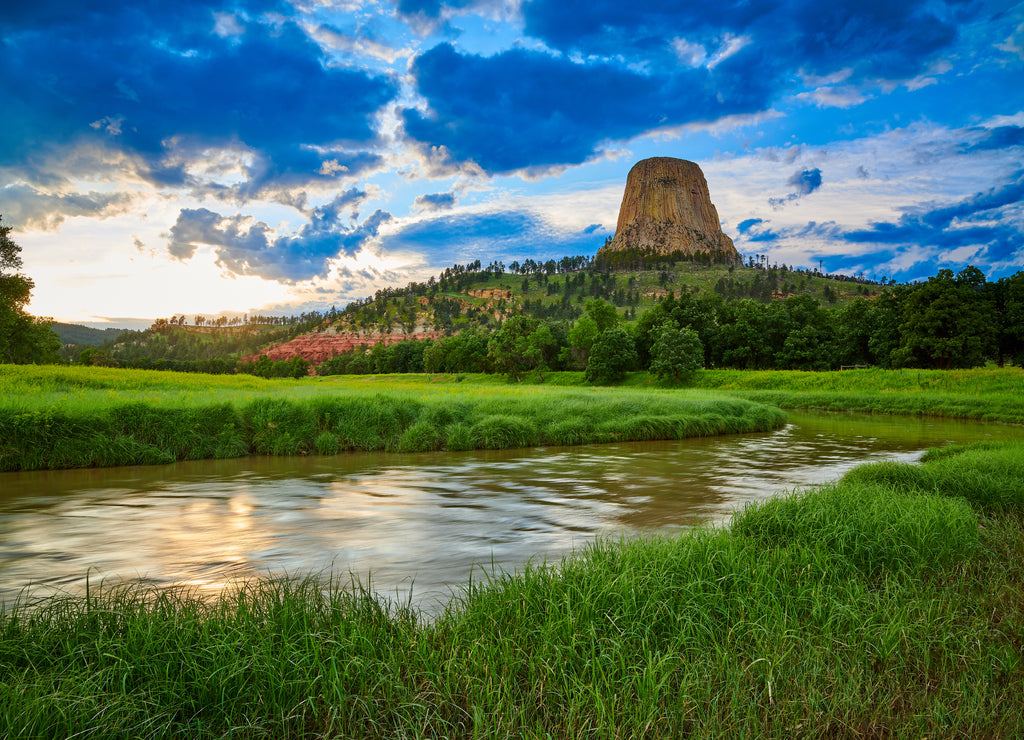 Sunset at Devils Tower National Monument with the Belle Fourche River in the foreground, Wyoming