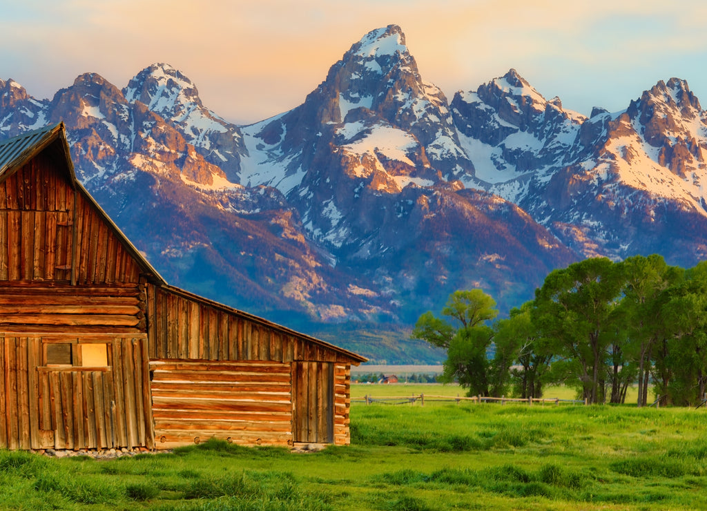 This abandoned, vintage barn in Mormon Row has the Grand Tetons in the background. Located in Jackson Hole, Wyoming, it is listed on the National Register of Historic Places