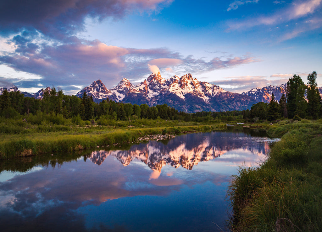 Sunrise view of Teton Range reflecting in calm Snake River in Grand Teton National Park, Wyoming, USA