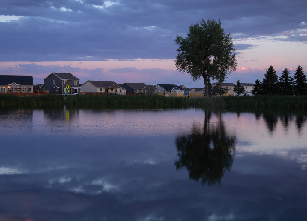 Reflection of a tree and the sky just after sunset in the water at Dalbey Memorial Park in Gillette, Wyoming