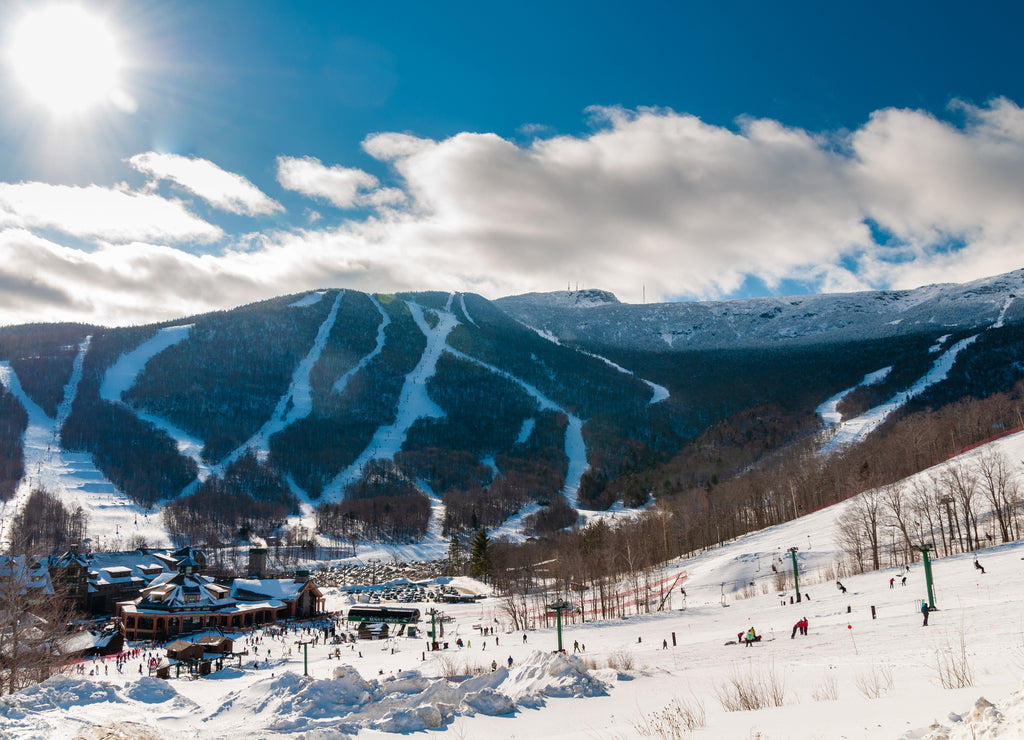 Spruce Peak Lodge in the winter with Mt. Mansfield in the background, Stowe, Vermont, USA