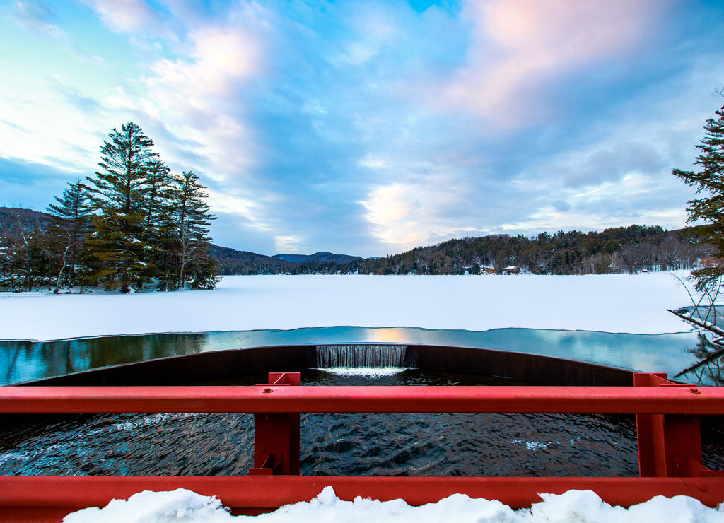 Sunset over the freezing lake on the red bridge - Vermont