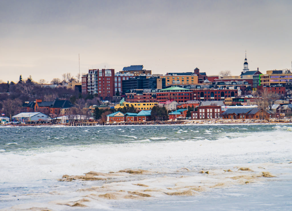view of Burlington, Vermont waterfront on Lake Champlain from Oakledge Park's winter coast line