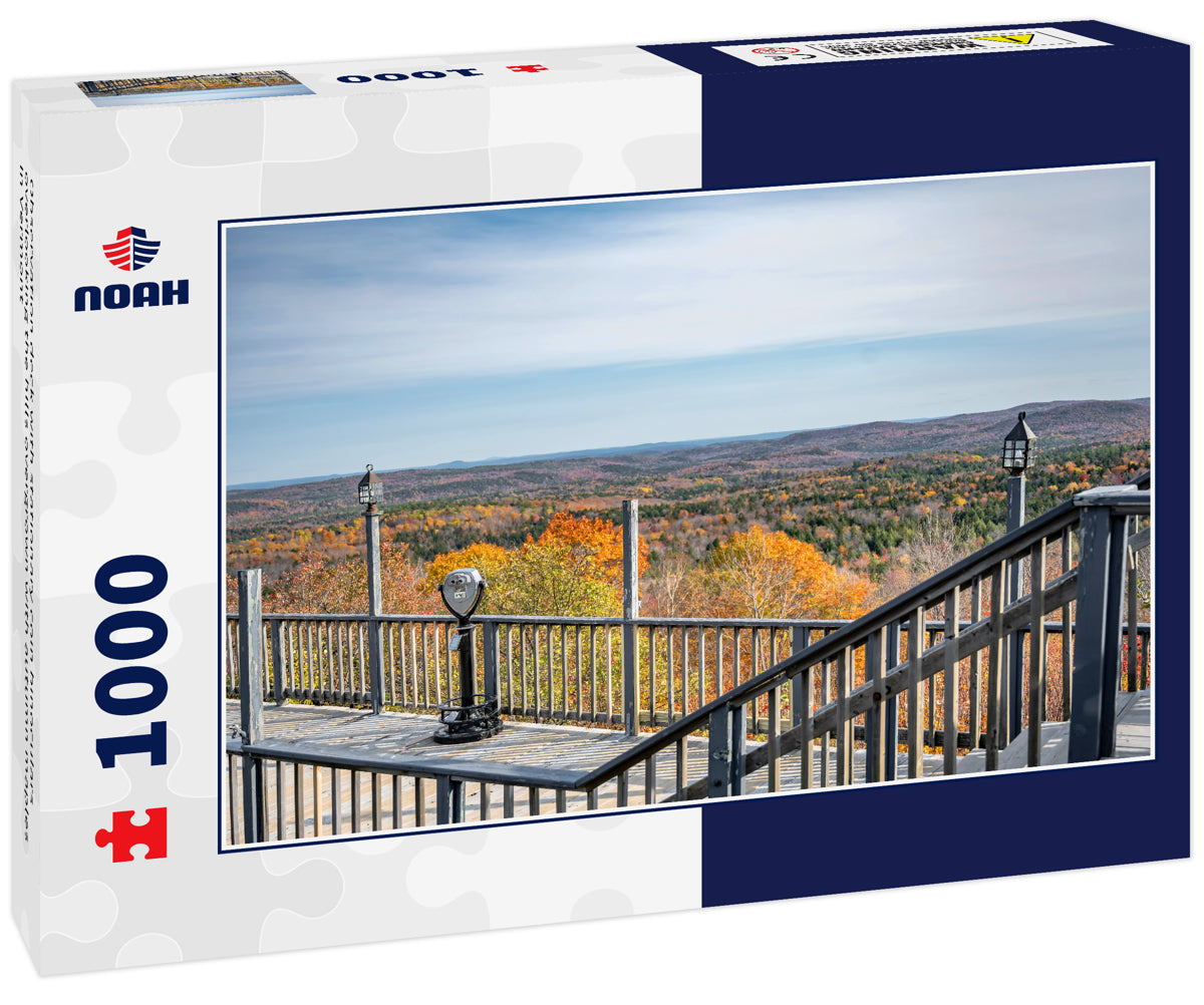Observation deck with stationary coin binoculars overlooking the hills overgrown with autumn maples in Vermont
