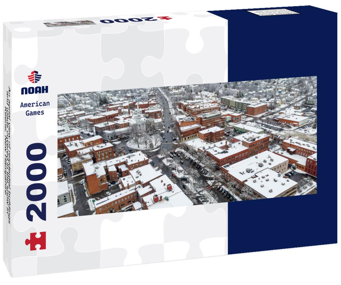 An aerial view of residential buildings and roads covered in the snow in Keene, New Hampshire 2000pc Panoramic Puzzle