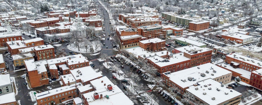 An aerial view of residential buildings and roads covered in the snow in Keene, New Hampshire 2000pc Panoramic Puzzle