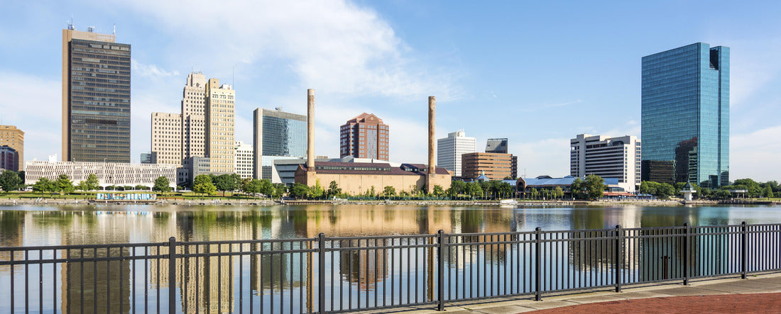 Noah Jigsaw Puzzle A panoramic view of downtown Toledo Ohio's skyline from across the Maumee river at a popular restaurant area with a paver brick boardwalk and a decorative iron railing panorama 2000 pieces