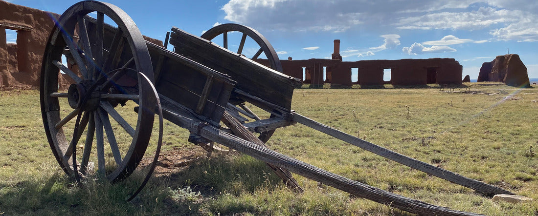 Fort Union National Monument in New Mexico. Preserves fort's adobe ruins along Santa Fe Trail. Remnants of Fort Union Depot Mechanic's Corral with wagons and wagon wheels 2000pc Panoramic Puzzle