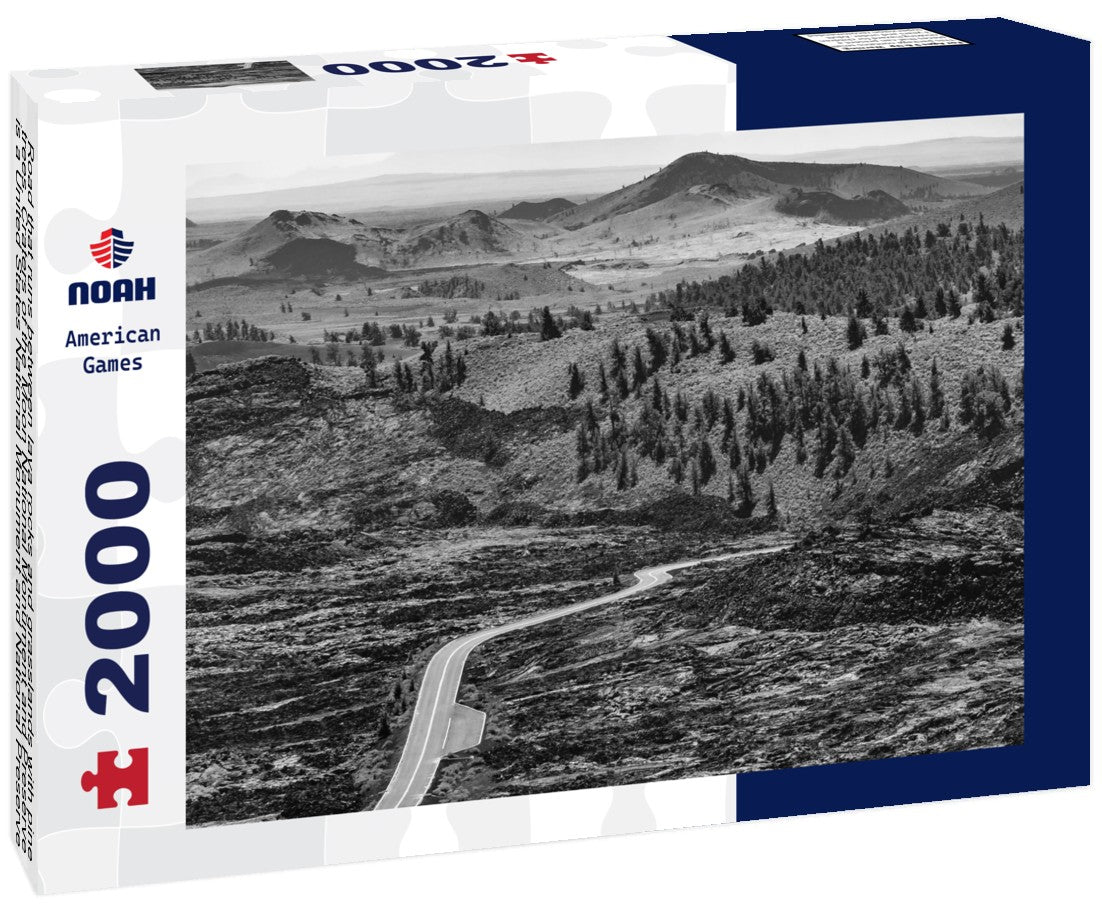 Road that runs between lava rocks and grasslands with pine trees. Craters of the Moon National Monument and Preserve is a United States National Monument and National Preserve on the Snake River Plain 2000pc PuzzleBlack and White