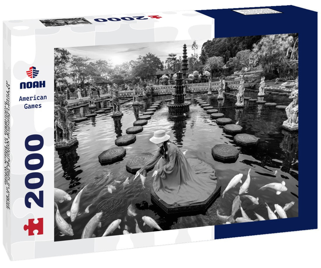 Noah Jigsaw Puzzle Woman feeding colorful fish in pond at Tirta Gangga Water Palace in Bali, Indonesia in black white 2000 pieces