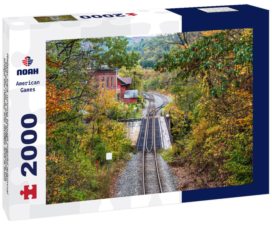 Noah Jigsaw Puzzle Railway track running trhough colorful autumnal tres and over a small bridge. Beyond the bridge the railway line divides and is lined with old buildings, Vermont 2000 pieces