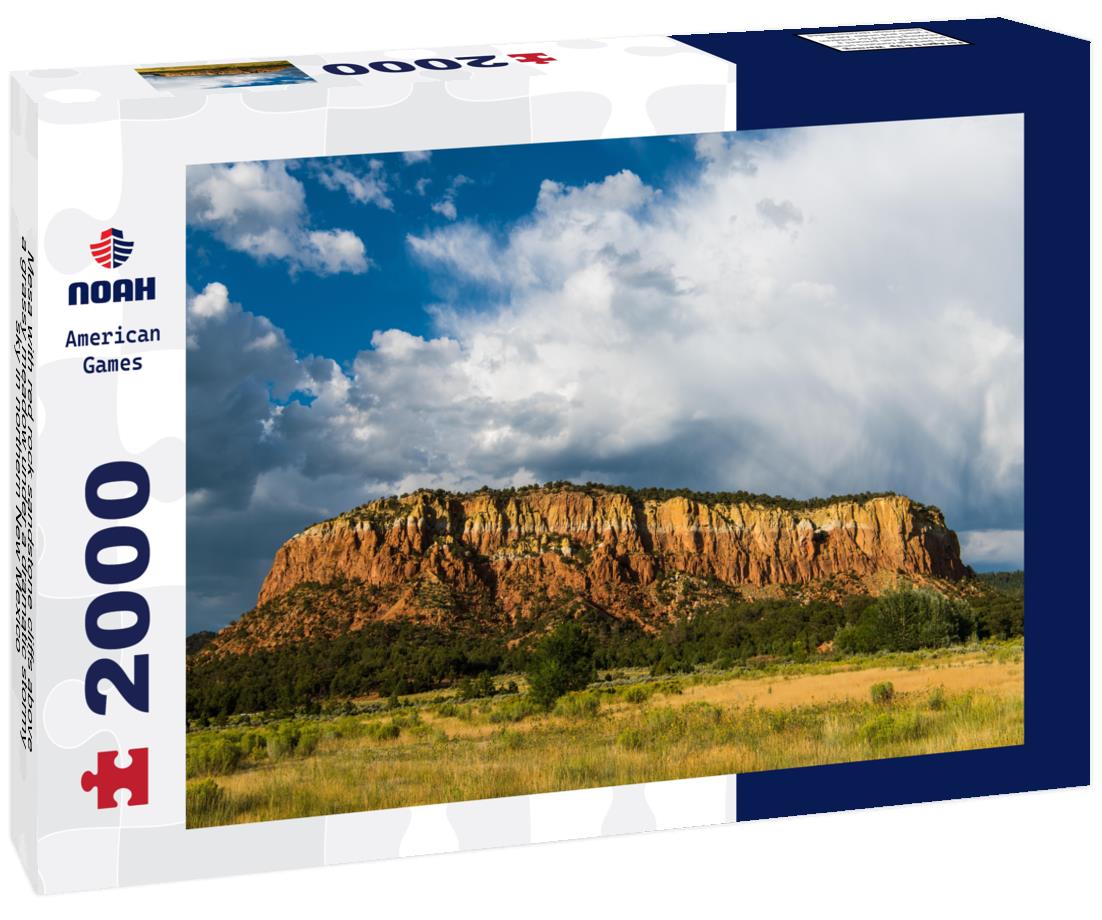 Noah Jigsaw Puzzle Mesa with red rock sandstone cliffs above a grassy meadow under a dramatic stormy sky in northern New Mexico 2000 pieces