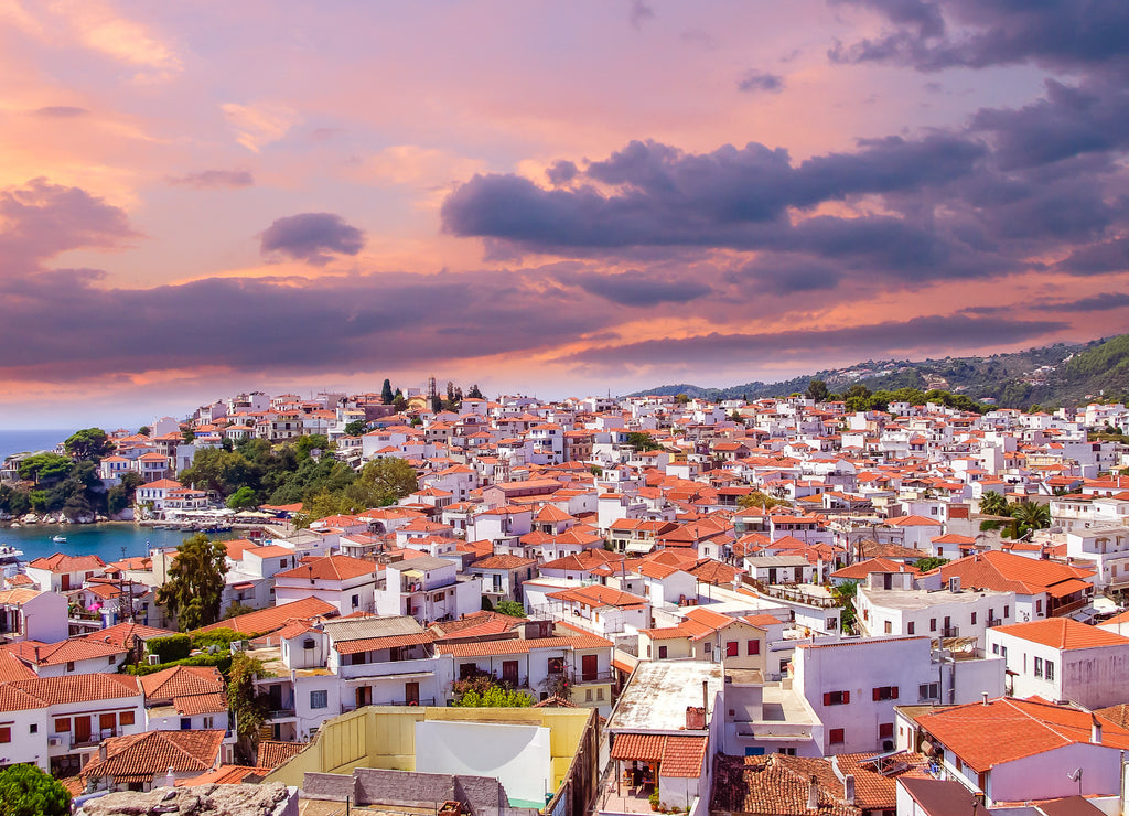 Sunset over Skiathos town on Skiatos Island, Greece. Beautiful view of the old town with boats in the harbour