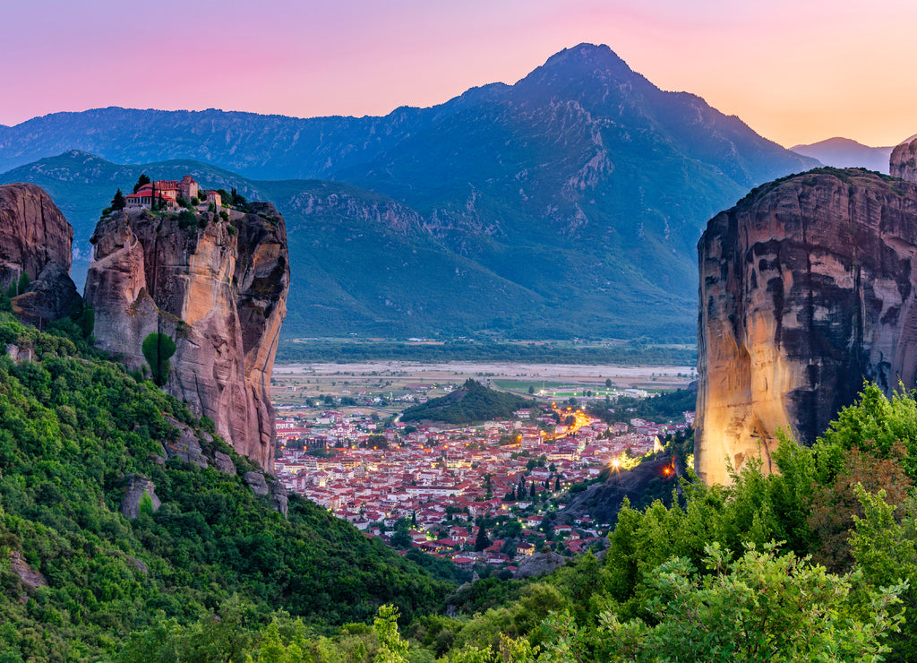 Tourist attraction to beautiful place of Meteora, monasteries on the cliffs in sunset light in Greece