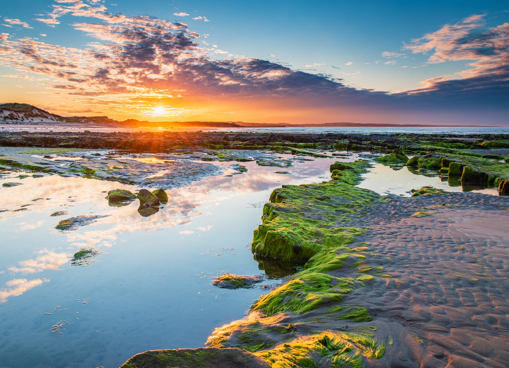 Sunset over Low Hauxley Rockpool / Low Hauxley Beach on the Northumberland coastline consists of both sandy areas and rocky outcrops